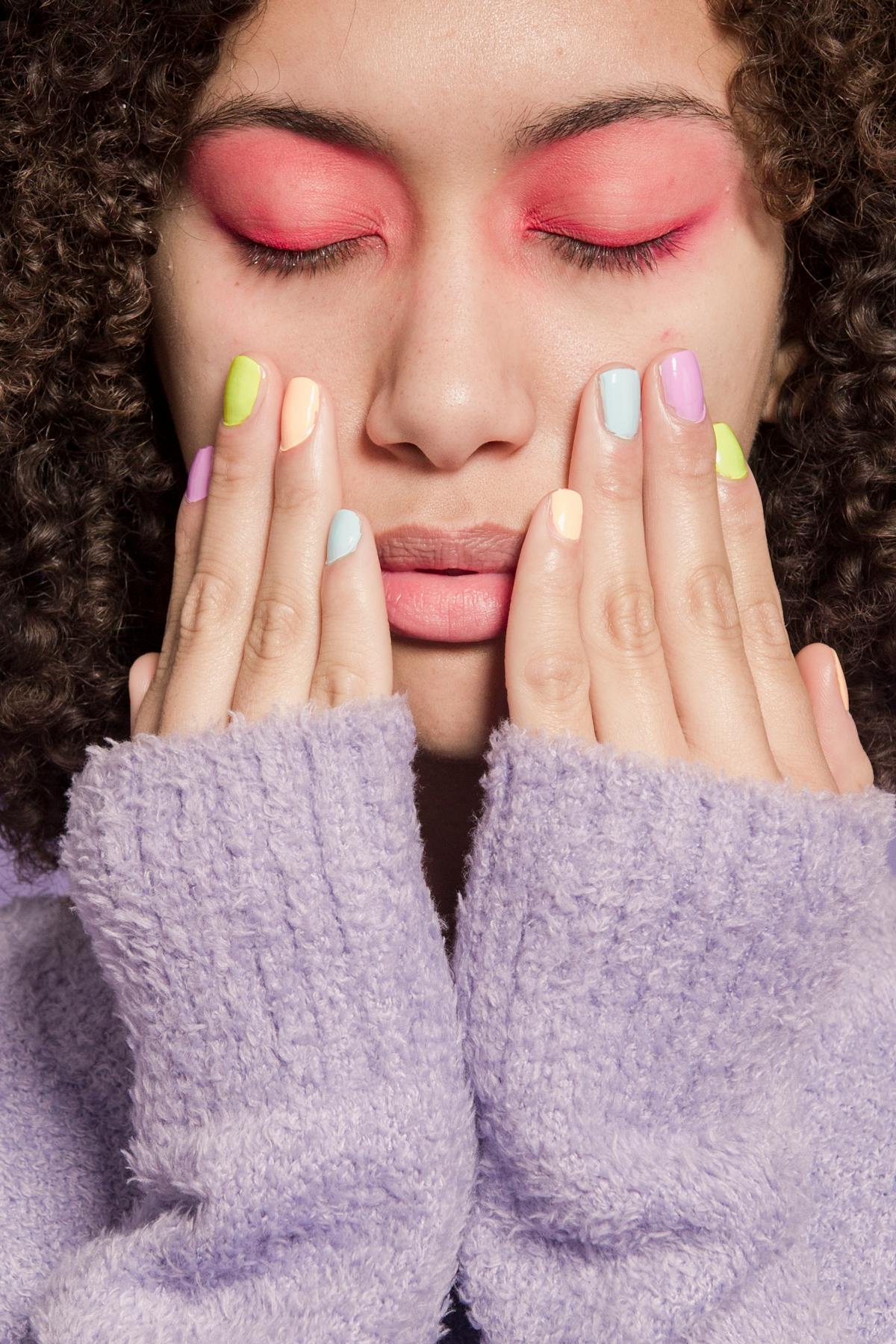 Pink shimmer polish being applied at the table